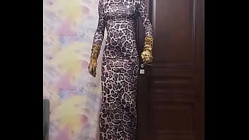 Crossdresser in leopard dress smokes and poses with vibrator plug
