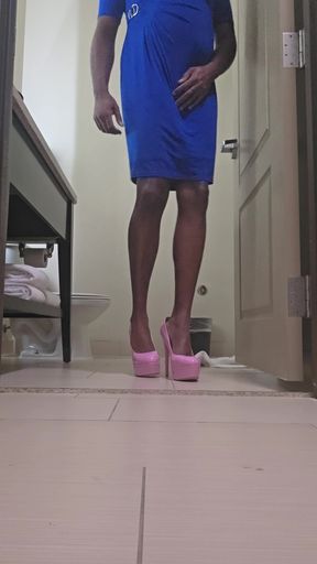 Pink platform heels and wearing a blue dress