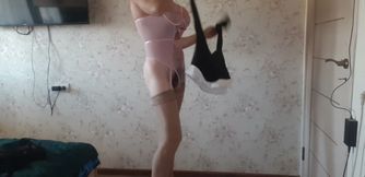 in a business suit, with a pink bodysuit underneath