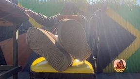 Public shoe dangle with foot play