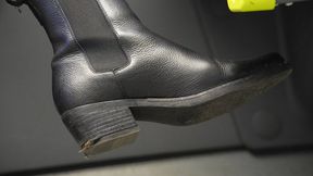 Bratty woman with dirty riding boot close-up. Boot fetish admiration and inspection.