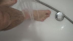 I stand in the tub and the water flows over my feet.