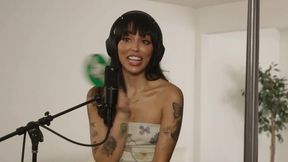 Brunette and blonde babes finger each other on a couch during an interview