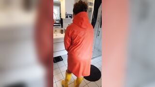 Trying on raincoats inside latex boots - long boobies