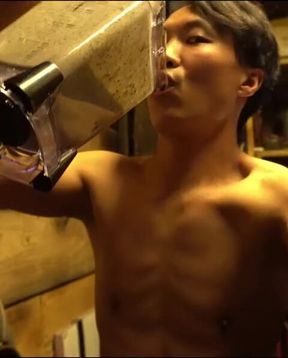 An Chinese man is guzzling a smoothie...