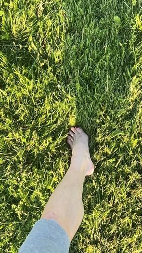 Naked feet in the park (slow motion)