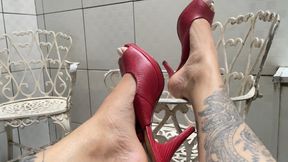 Queen Jessy shows off her perfect feet in red platform heels.