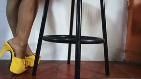 Tapping high heels against the heel of her feet (3)