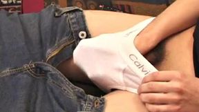 Travis Martinez starts out on the sofa to strip naked and get his dick boned up. Then he is all over the place, as he strokes hard and makes his big balls bounce. Eventually the horny young man blows his load.