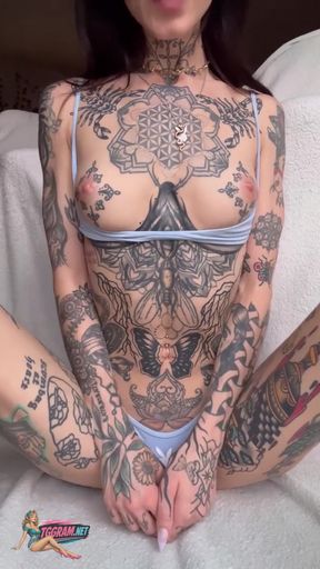 Blonde teen with tattooed boobs poses in a pro shot while remaining