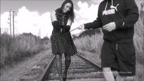 Lady in polka dot dress tied to the tracks