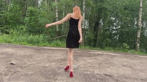 A girl in very high-heeled shoes goes out for a walk because it's very stuffy in the car, but there's too much dirt outside that gets all her shoes and toes dirty