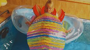 Alla inflates a large rare beach ball with her mouth and floats on an inflatable boat in the pool!!!