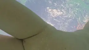 Curvy mom plays with anal plug in public pool