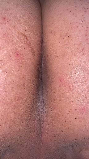 A man exposes his asshole. Take a close-up shot so you can see the wrinkles clearly