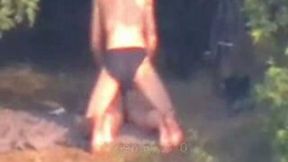 Peeking on one amateur couple having fun on the lake shore