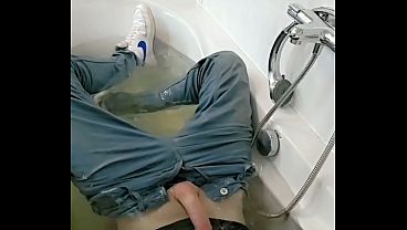 Playing with cock and ass in wet jeans and sneakers