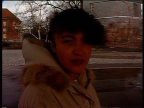 Brunette beauty giving an outdoor interview in german vintage video