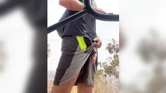 Hairy muscular guy strokes his big uncut cock on public street
