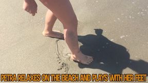 Petra relaxes on the beach and plays with her feet - HD