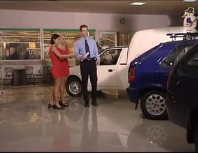 Two Girls in Red Dresses Have Fun at the Car Dealer