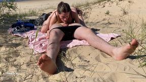 Nudist couple enjoying blowjob at the beach