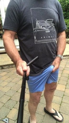 commando in thin blue shorts outdoors