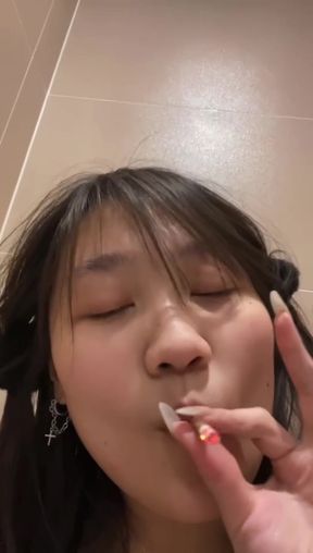 Teenage Chinese girl smokes and shows off her body