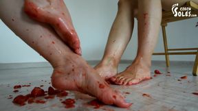 Two sexy foot girls crushing strawberries under their soles