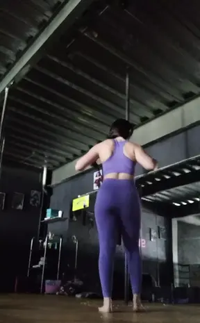 Fit gym girl in sexy yoga pants and sports bra