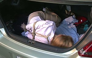 Woman tied up and in the back of a car —