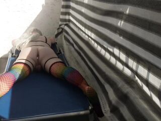 Caged sissy plays with her vibrator on public balcony