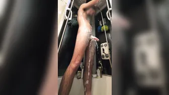 Twink soaps up his big uncut cock in the shower