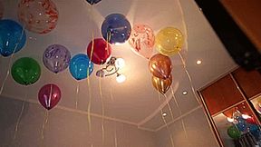 Girls barefoot pop all helium balloons