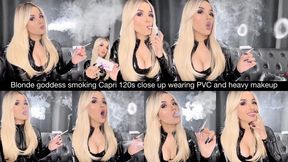 Blonde goddess smoking capri 120s close up wearing a PVC catsuit, black eyeshadow and glossy lips!