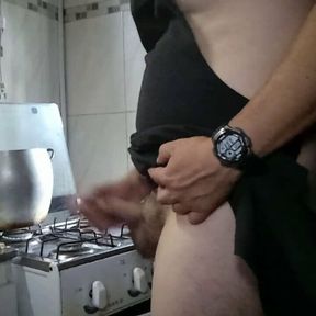 Sexy man at the kitchen cooking nude.