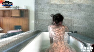 Marseline Black explores her tattooed body with fingers in bath and bedroom