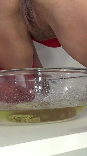 A MILF in Red Is Peeing Into a Basin.