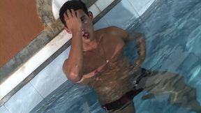 Latino dude jerking his dick nex to swimming pool