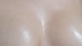 sensual woman massages her breasts with oil