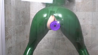 Lilou masturbates in the shower in green latex