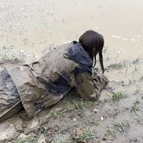 Muddy fields, rain suit in the rain