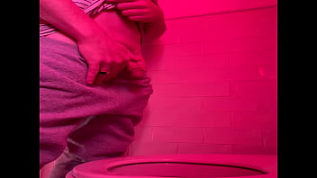 Guy pissing in the toilets of a bar