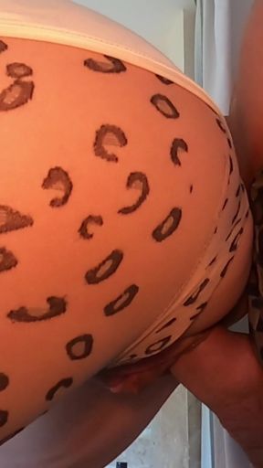 Teasing in a Sheer Leopard Outfit.