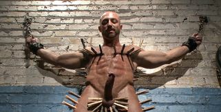 Bald bodybuilder has his entire body covered while bound