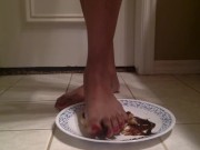 Tgirl crushes a chocolate donut under her foot