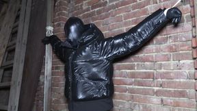 Tied up on attic in a leather hood and down jacket