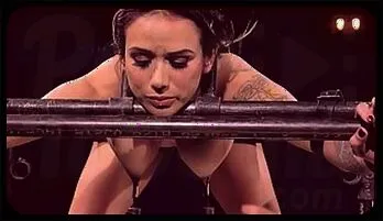 Bound Brunette Beauty in Metal Restraints with Nipple Clamps