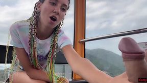 Playful chick jerks a random guy's cock off on a Ferris Wheel