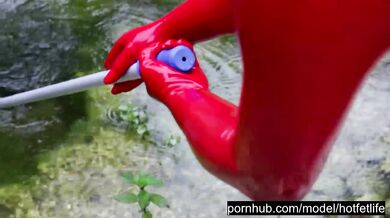 Blonde latex goddess pisses outside in red catsuit and heels